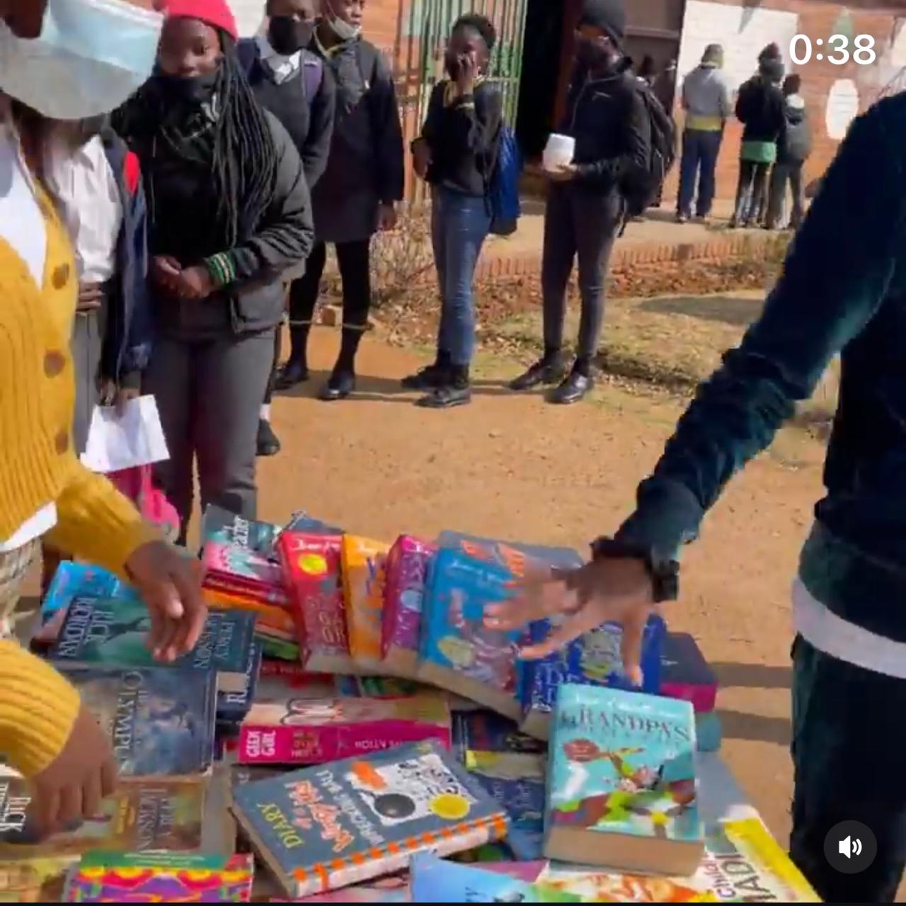Children choosing books from a table
