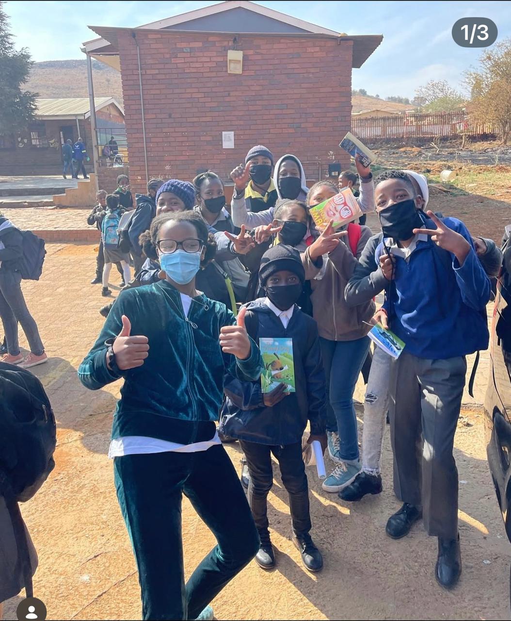 Learners celebrating with donated books